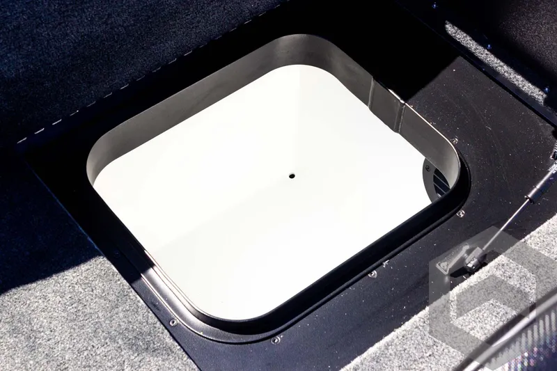 Slide: The Image of 2025 Skeeter FXR 21 Limited boat storage compartment, open and empty. - 49