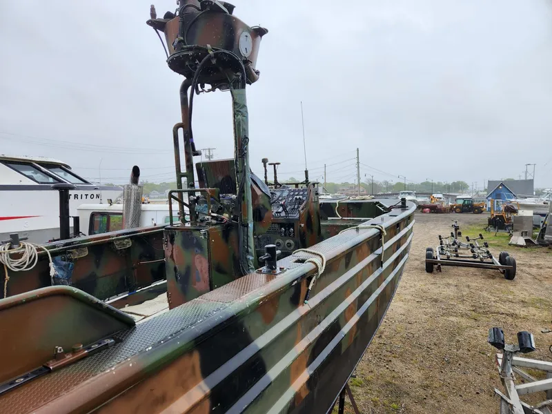 Slide: The Image of Camouflaged 1999 Recon SWCC Special Operations Vessel on land, showcasing military design and equipment. - 10