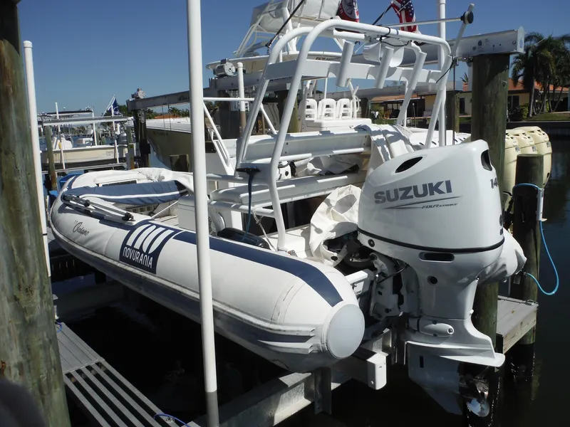 Slide: The Image of Novurania MX 530 DL boat with Suzuki outboard motor docked at marina, 2000 model. - 0