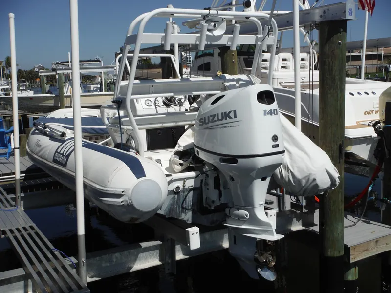Slide: The Image of Novurania MX 530 DL boat with Suzuki 140 outboard motor, docked at marina. - 14