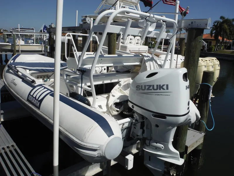 Slide: The Image of 2000 Novurania MX 530 DL inflatable boat with Suzuki outboard motor docked at marina. - 15