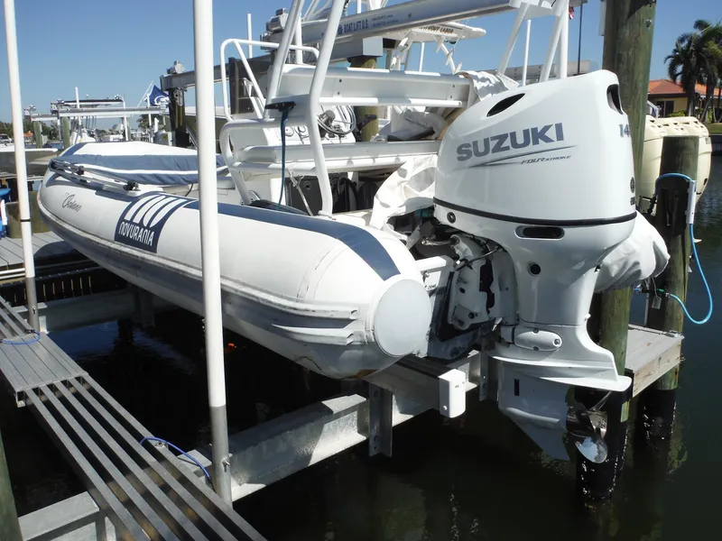 Slide: The Image of Novurania MX 530 DL boat with Suzuki outboard motor docked at marina, 2000 model. - 16