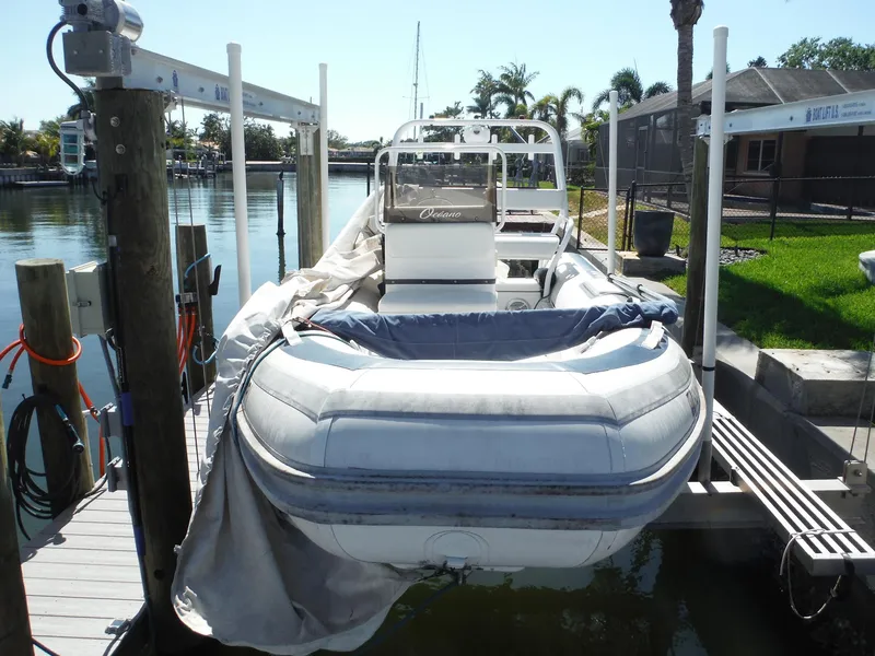 Slide: The Image of Novurania MX 530 DL boat from 2000 docked by a waterfront property. - 5