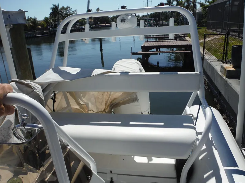 Slide: The Image of 2000 Novurania MX 530 DL boat docked by a calm waterfront. - 7