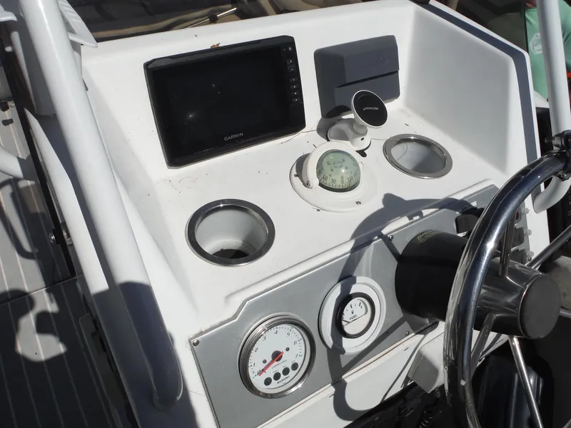Slide: The Image of Control panel of a 2000 Novurania MX 530 DL boat with gauges and steering wheel. - 8