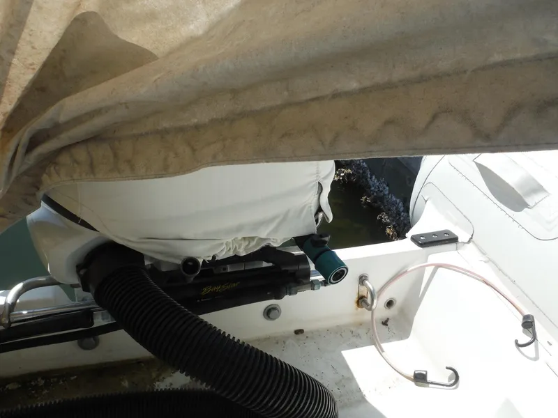 Slide: The Image of Novurania MX 530 DL boat interior, partially covered, showing engine and equipment, year 2000 model. - 9