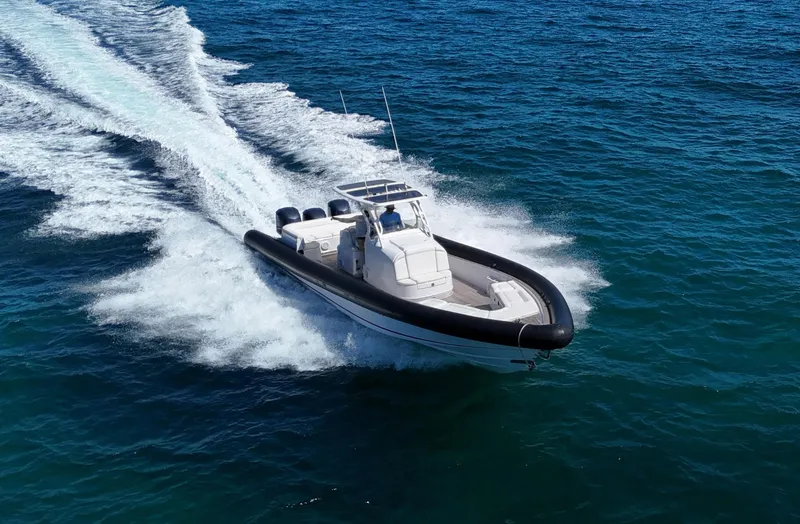 Slide: The Image of 2013 Yellowfin 40 boat speeding on open blue water. - 1