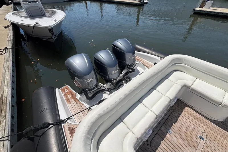 Slide: The Image of 2013 Yellowfin 40 boat with triple outboard engines docked at marina. - 10