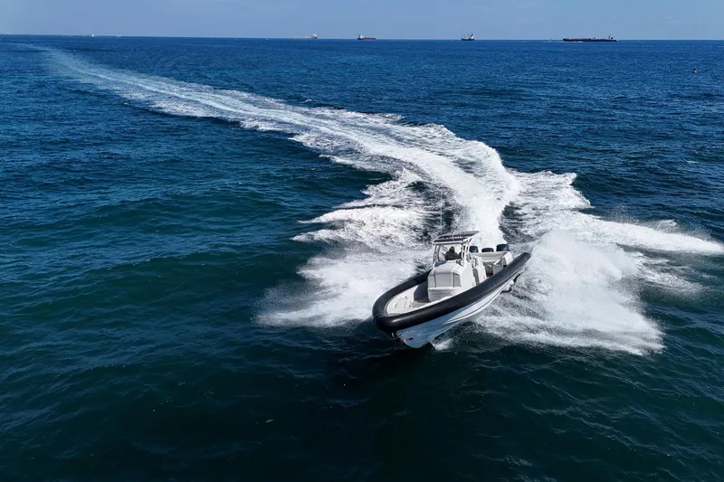 Slide: The Image of 2013 Yellowfin 40 boat speeding on open ocean, leaving a white wake trail. - 11