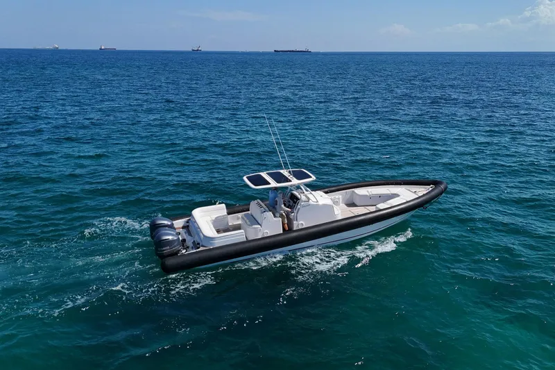 Slide: The Image of 2013 Yellowfin 40 boat cruising on open blue ocean waters. - 15