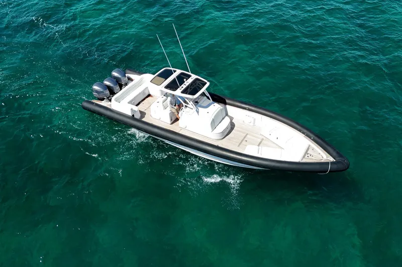 Slide: The Image of 2013 Yellowfin 40 boat cruising on clear blue water. - 16