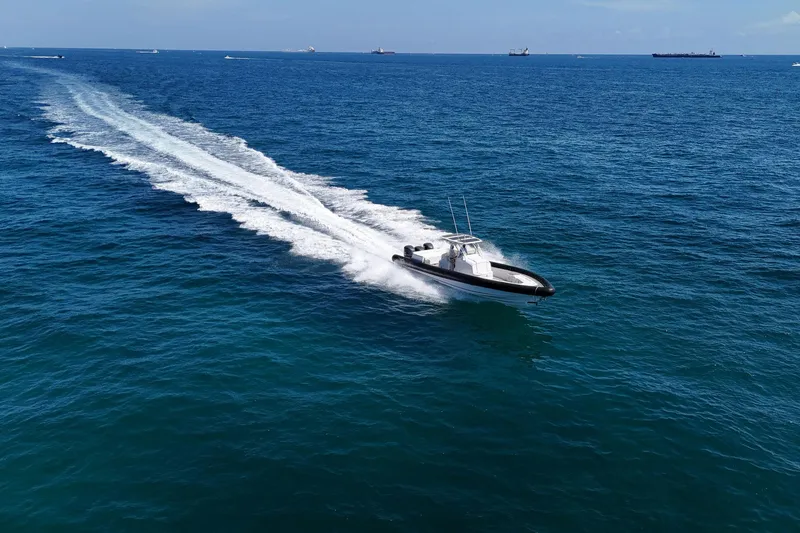 Slide: The Image of 2013 Yellowfin 40 boat cruising on open blue ocean waters. - 18