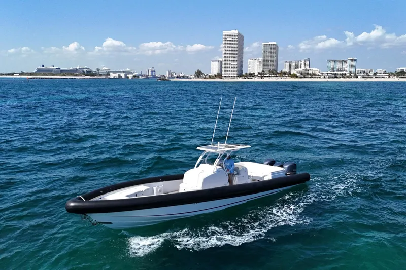 Slide: The Image of 2013 Yellowfin 40 boat cruising on blue ocean near city skyline. - 19