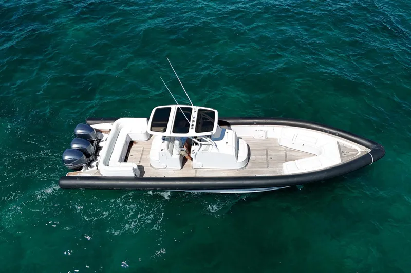 Slide: The Image of 2013 Yellowfin 40 boat cruising on clear blue water, aerial view. - 3