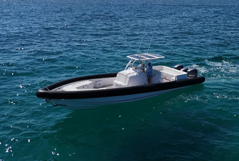 Slide: The Image of 2013 Yellowfin 40 boat cruising on clear blue ocean waters. - 4