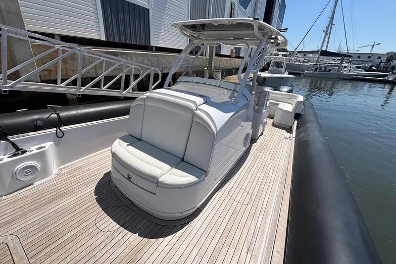 Slide: The Image of 2013 Yellowfin 40 boat with sleek design, docked at marina, featuring spacious seating and modern amenities. - 6