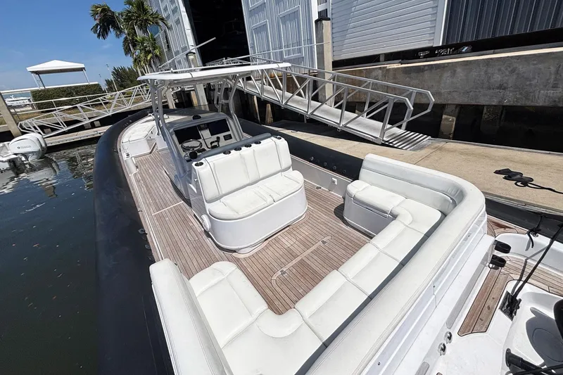 Slide: The Image of 2013 Yellowfin 40 boat with spacious seating, docked near a marina. - 9