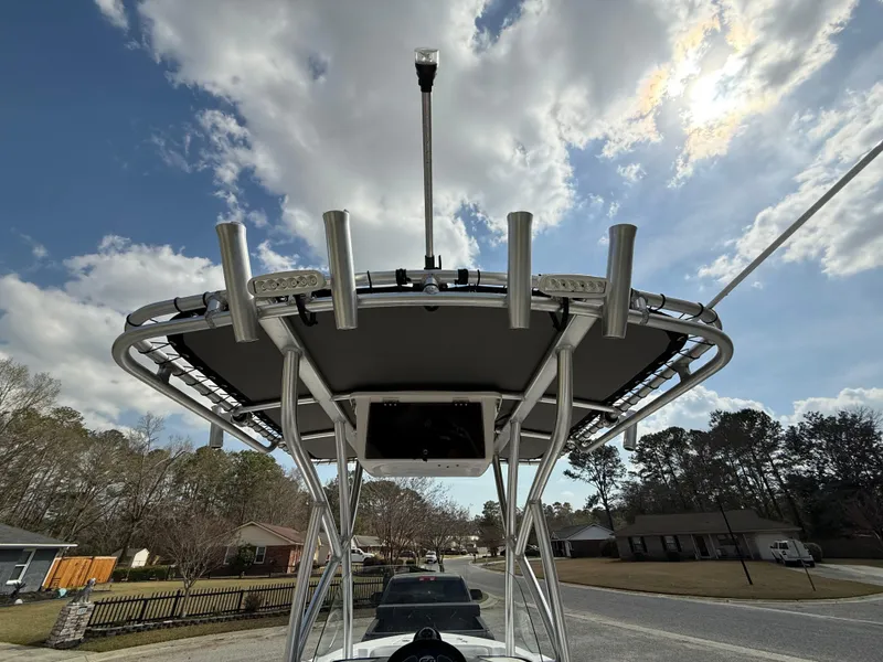 Slide: The Image of 2020 Sea Fox 206 Commander boat with T-top under a partly cloudy sky. - 18