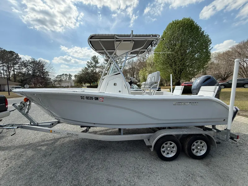 Slide: The Image of 2020 Sea Fox 206 Commander boat on trailer, parked outdoors under a cloudy sky. - 2