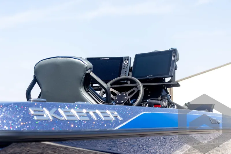 Slide: The Image of 2023 Skeeter ZXR 20 boat dashboard with steering wheel and navigation screens. - 12