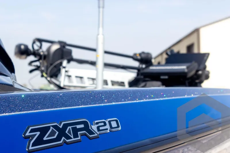 Slide: The Image of 2023 Skeeter ZXR 20 boat, close-up of logo and sleek blue design. - 19