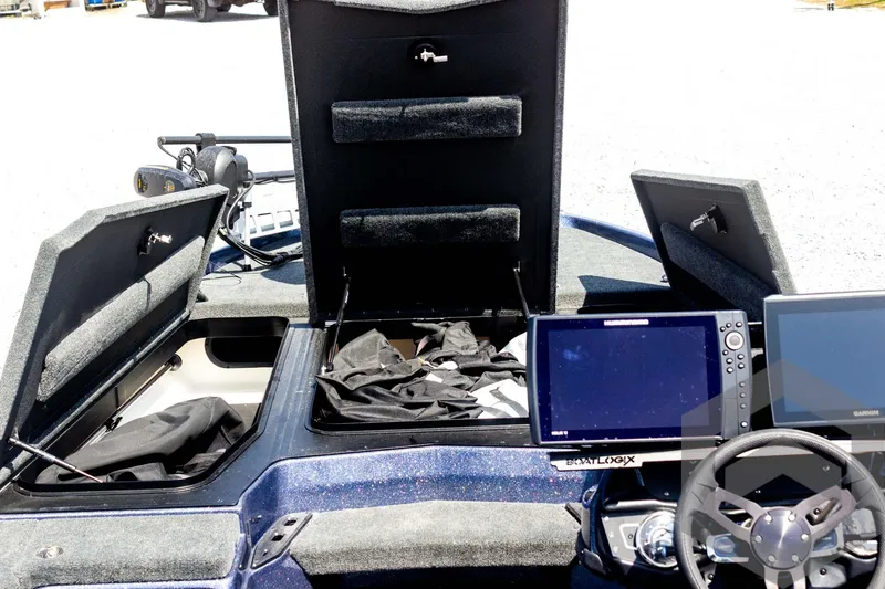 Slide: The Image of 2023 Skeeter ZXR 20 boat interior with open storage compartments and navigation screens. - 21