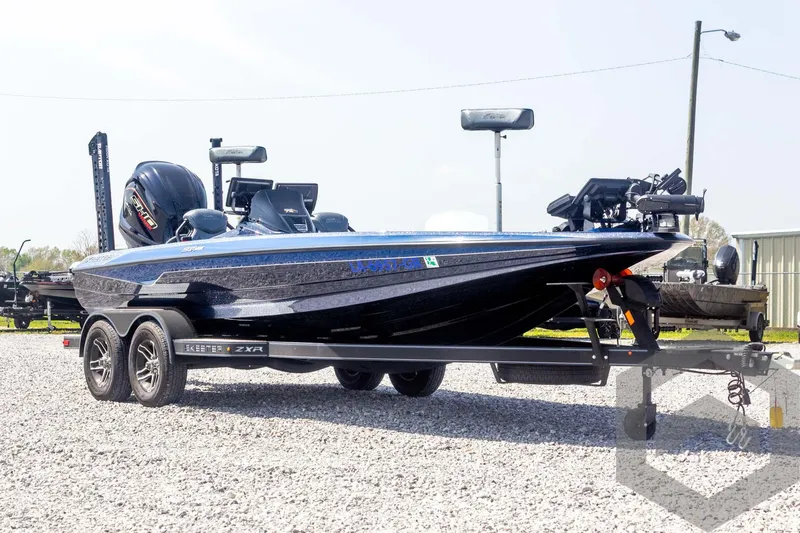 Slide: The Image of 2023 Skeeter ZXR 20 boat on trailer, parked on gravel lot. - 3