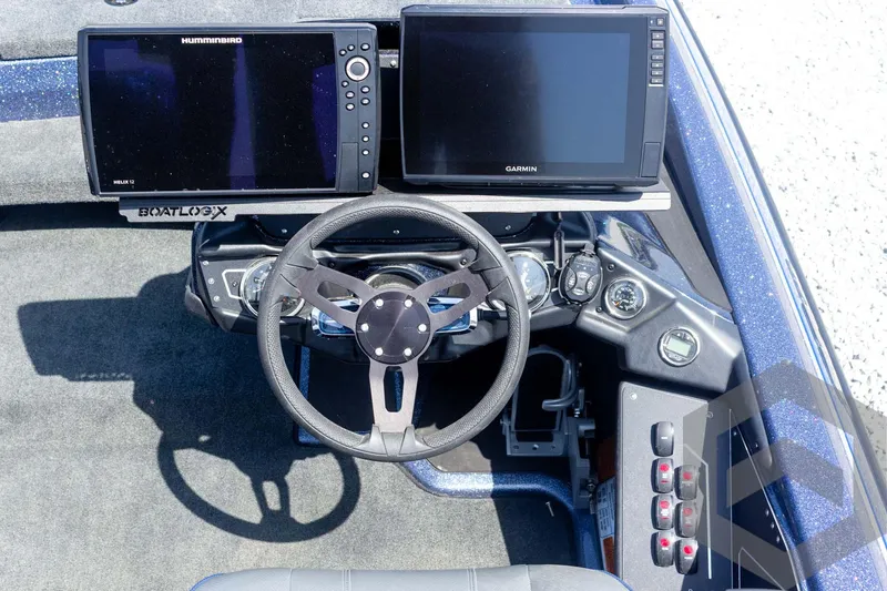 Slide: The Image of 2023 Skeeter ZXR 20 boat dashboard with dual navigation screens and steering wheel. - 32