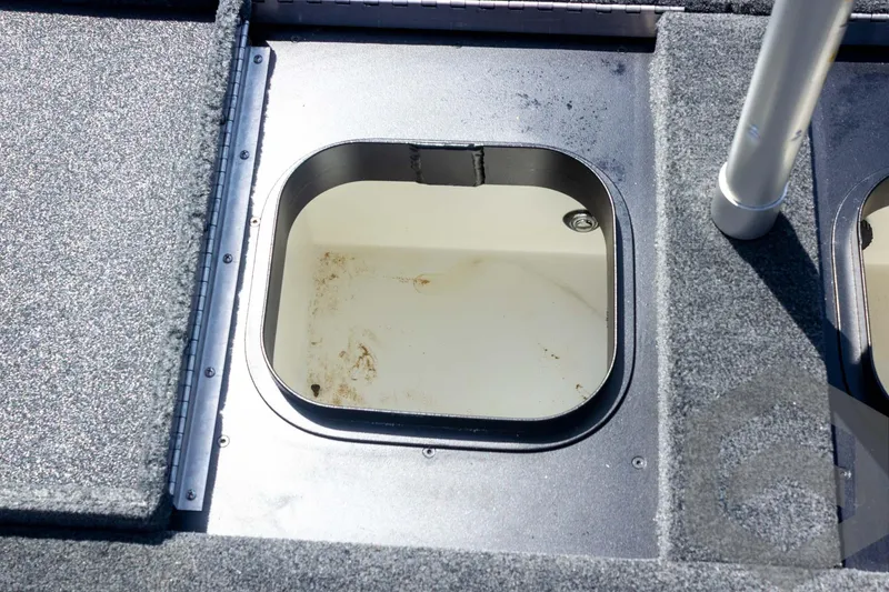 Slide: The Image of 2023 Skeeter ZXR 20 boat storage compartment with open hatch, showing interior details. - 44