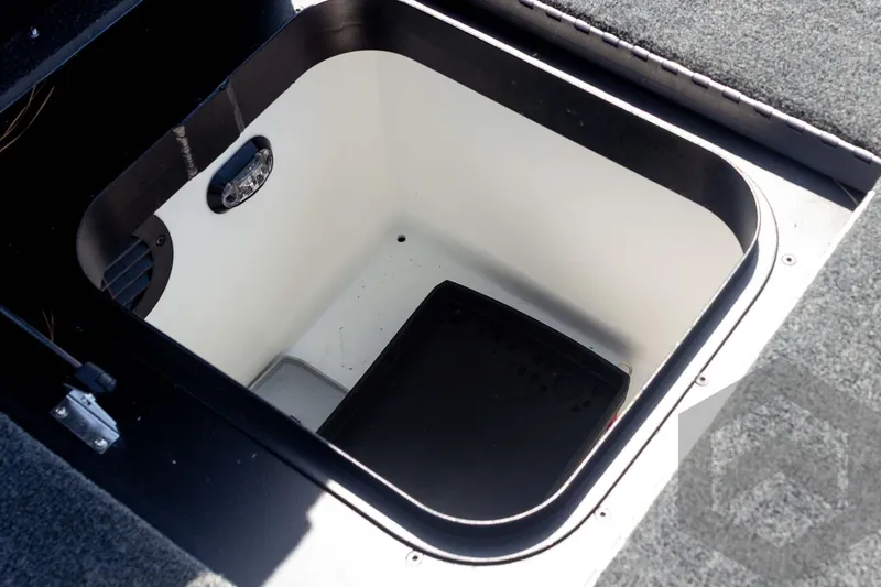 Slide: The Image of 2023 Skeeter ZXR 20 boat storage compartment with black and white interior. - 45