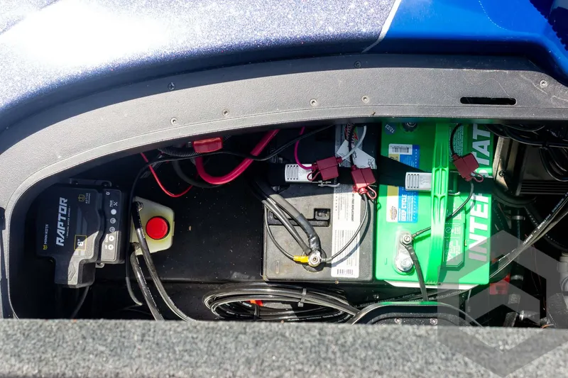 Slide: The Image of 2023 Skeeter ZXR 20 boat battery compartment with wiring and components. - 46