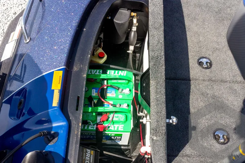 Slide: The Image of 2023 Skeeter ZXR 20 boat battery compartment with green batteries and wiring. - 47
