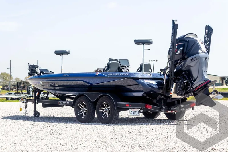 Slide: The Image of 2023 Skeeter ZXR 20 boat on trailer, parked on gravel. - 7