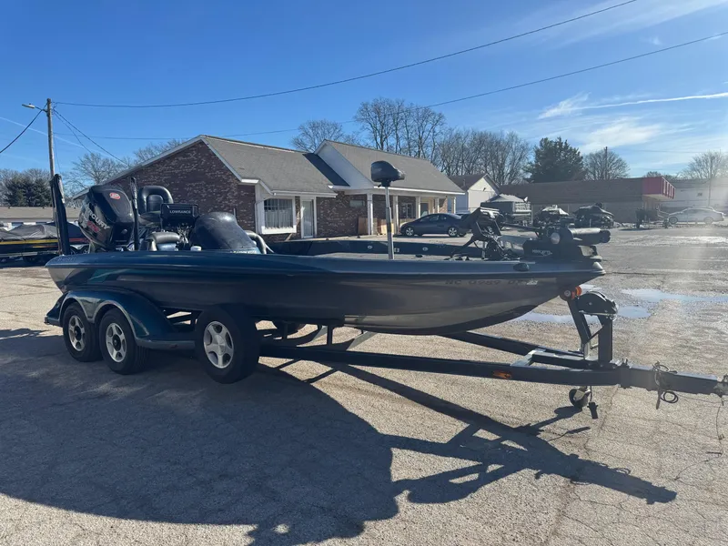 Slide: The Image of 2000 Ranger 520SVX Comanche boat on trailer in sunny parking lot. - 5