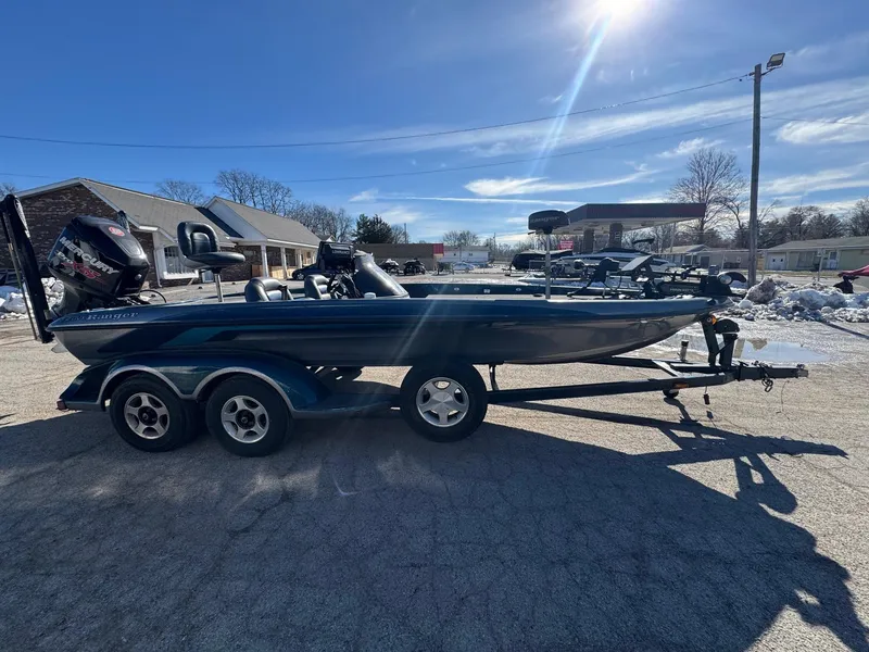 Slide: The Image of 2000 Ranger 520SVX Comanche boat on trailer under clear blue sky. - 6