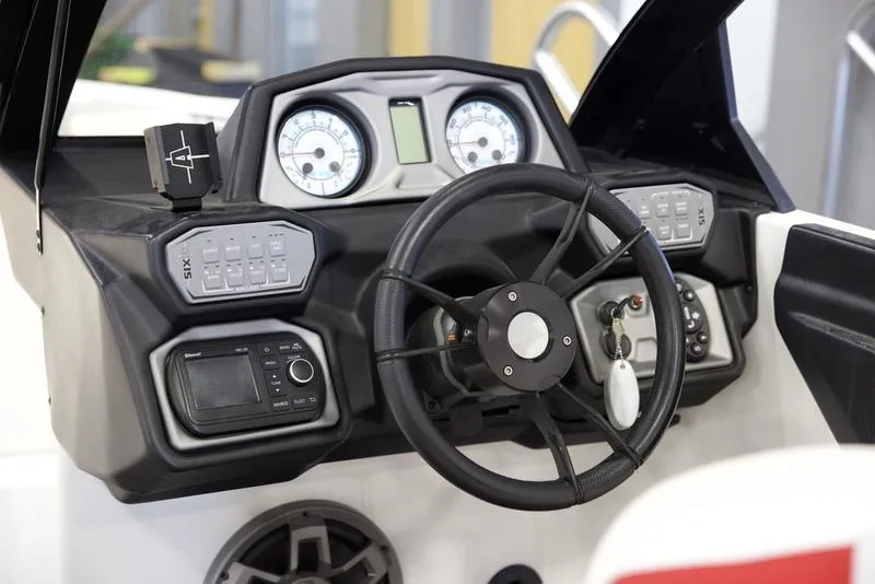 Slide: The Image of 2020 Axis A24 boat dashboard with steering wheel and control panels. - 12