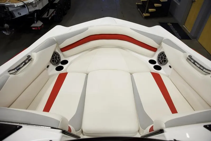 Slide: The Image of 2020 Axis A24 boat interior with red and white seating, cup holders, and speakers. - 14
