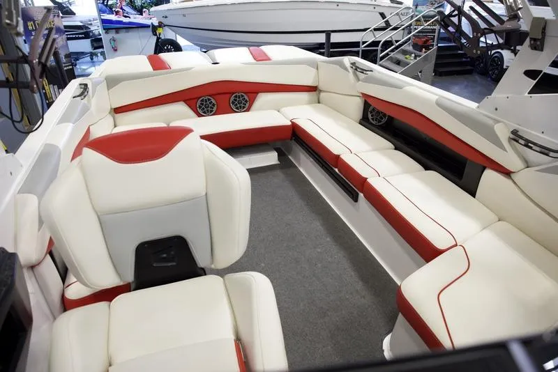 Slide: The Image of 2020 Axis A24 boat interior with white and red seating, featuring built-in speakers. - 18