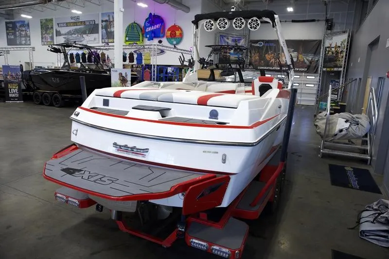 Slide: The Image of 2020 Axis A24 boat in showroom, featuring sleek design and vibrant red accents. - 8