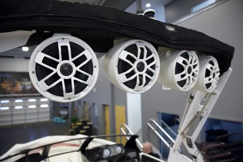 Slide: The Image of 2020 Axis A24 boat with mounted white speakers in a showroom. - 9