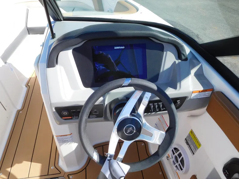 Slide: The Image of 2025 Chaparral 21 SSi boat dashboard with steering wheel and digital display. - 3