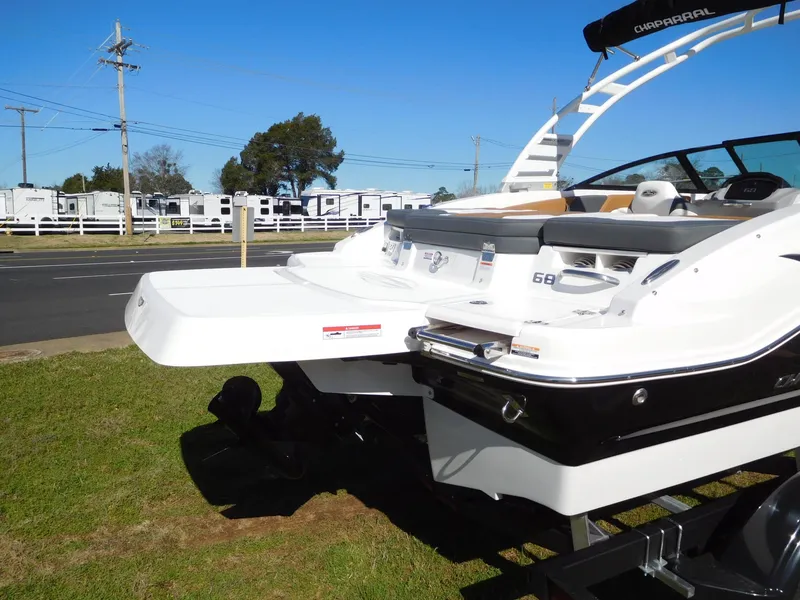 Slide: The Image of 2025 Chaparral 21 SSi boat, rear view, on grass near road. - 8