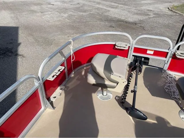 Slide: The Image of 2014 Sun Tracker BASS BUGY boat interior with red railing and seating. - 10