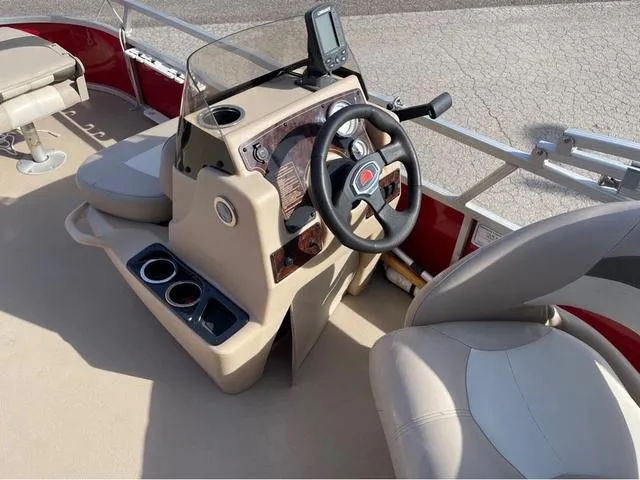 Slide: The Image of 2014 Sun Tracker BASS BUGY boat interior with steering wheel and seating. - 11
