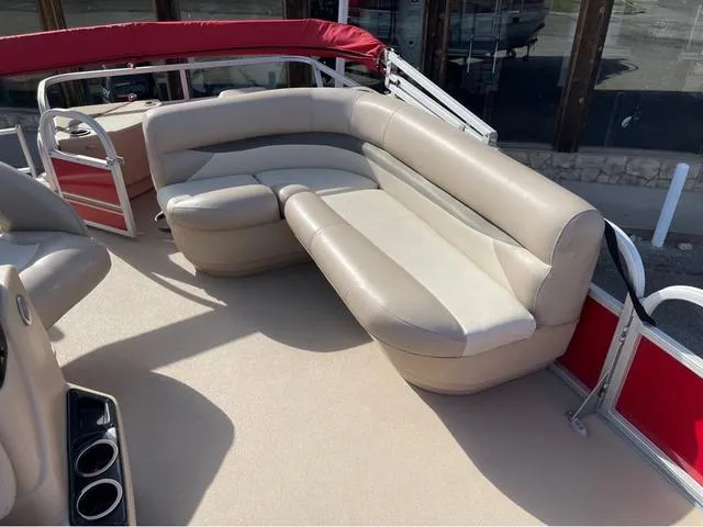 Slide: The Image of 2014 Sun Tracker BASS BUGY boat with beige seating and red accents. - 12
