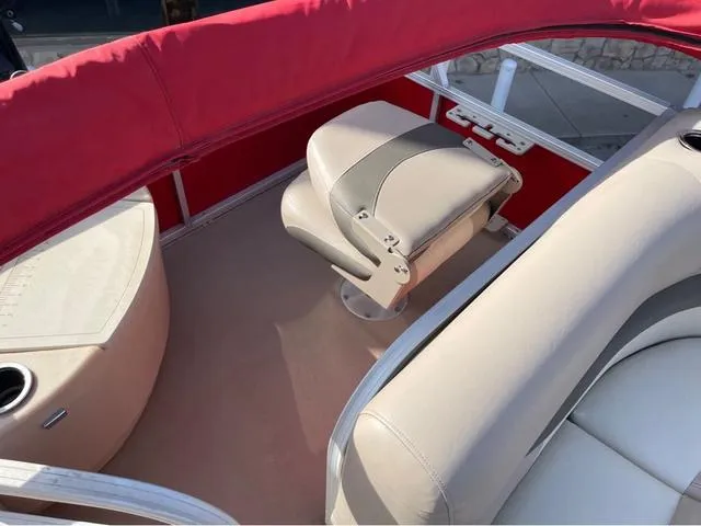 Slide: The Image of 2014 Sun Tracker BASS BUGY interior with beige seating and red canopy. - 14