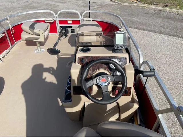 Slide: The Image of 2014 Sun Tracker BASS BUGY boat interior with steering wheel and fish finder. - 15