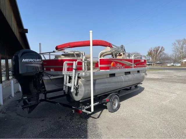 Slide: The Image of 2014 Sun Tracker BASS BUGY pontoon boat on trailer, featuring Mercury outboard motor. - 3