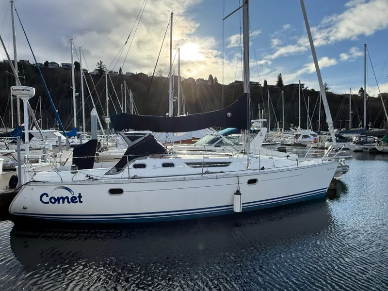 Slide: The Image of 1999 Jeanneau Sun Odyssey 36.2 sailboat docked in marina under cloudy sky. - 0