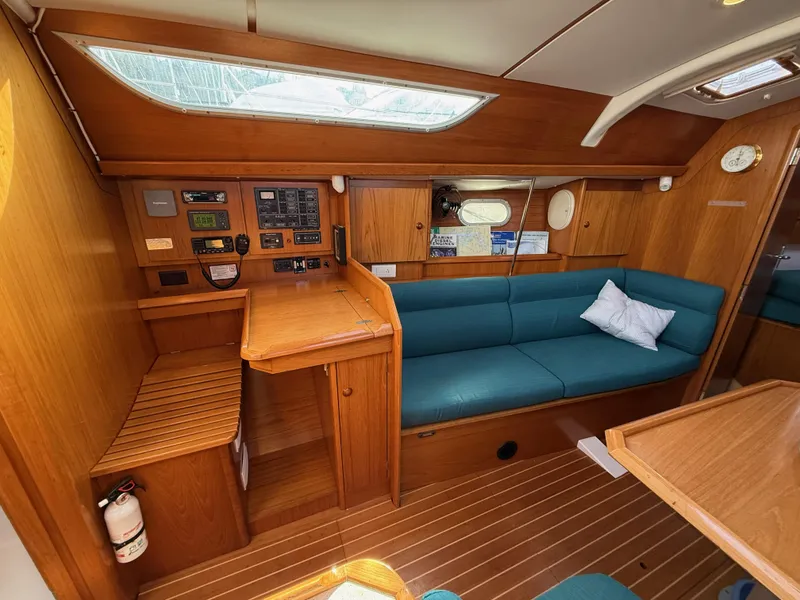 Slide: The Image of Cozy interior of 1999 Jeanneau Sun Odyssey 36.2 sailboat with wooden finish and blue seating. - 10